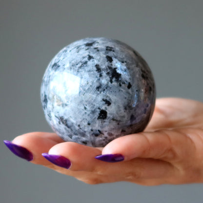 larvikite crystal ball in palm of hand