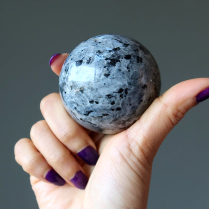 larvikite crystal ball in hand